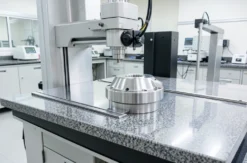 Coordinate measuring machine measuring a large machined steel part in a quality lab
